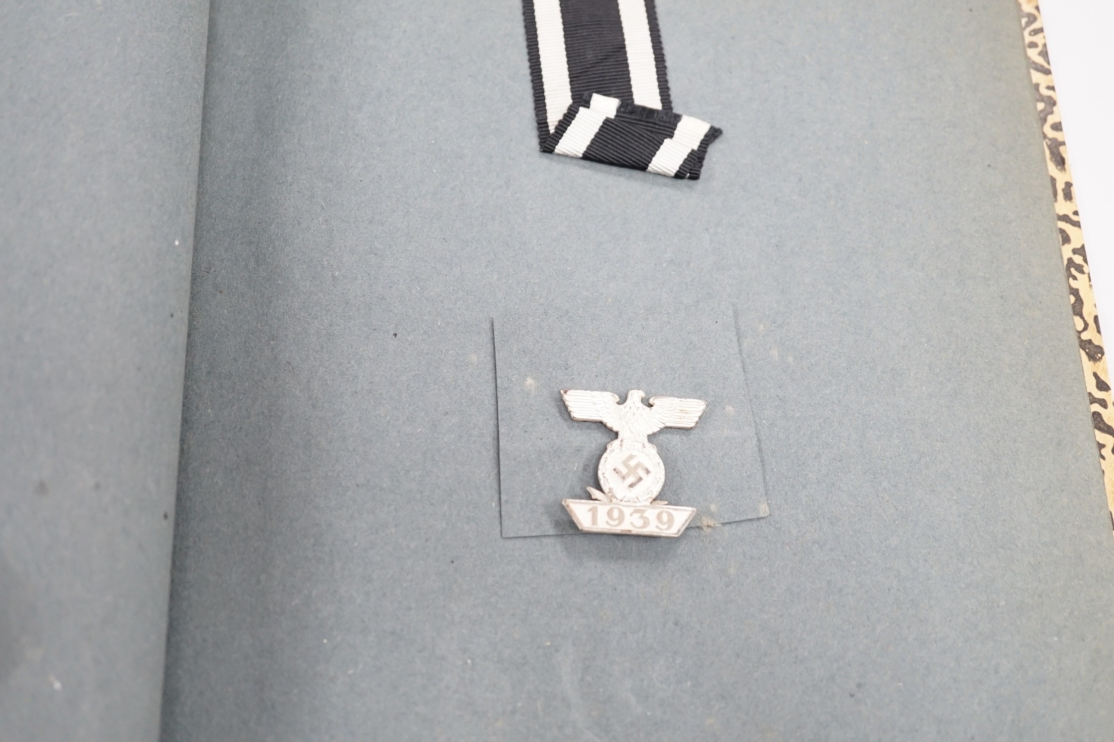 WWII interest album of postcards, printed ephemera and medals relating to Allied expeditionary force, Adolf Hitler headed paper, German medals, Berlin Olympic stadium, banknotes etc.